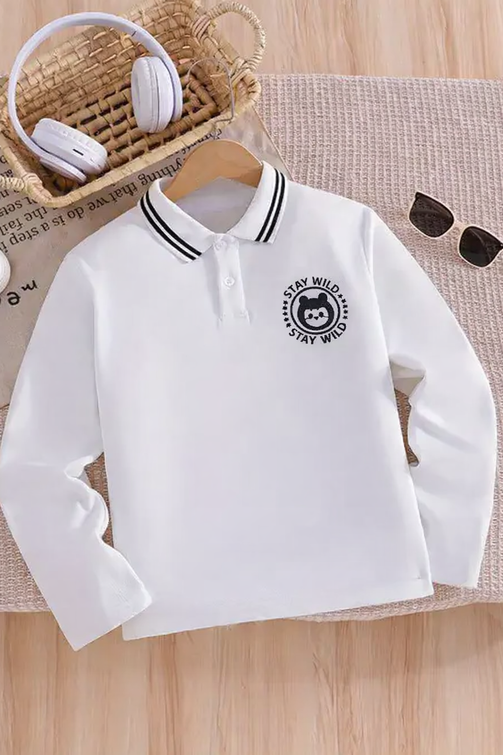 Kids’ White Long-Sleeve Polo Shirt with Black Tipped Collar – “Stay Wild” Bear Embroidered Chest Badge